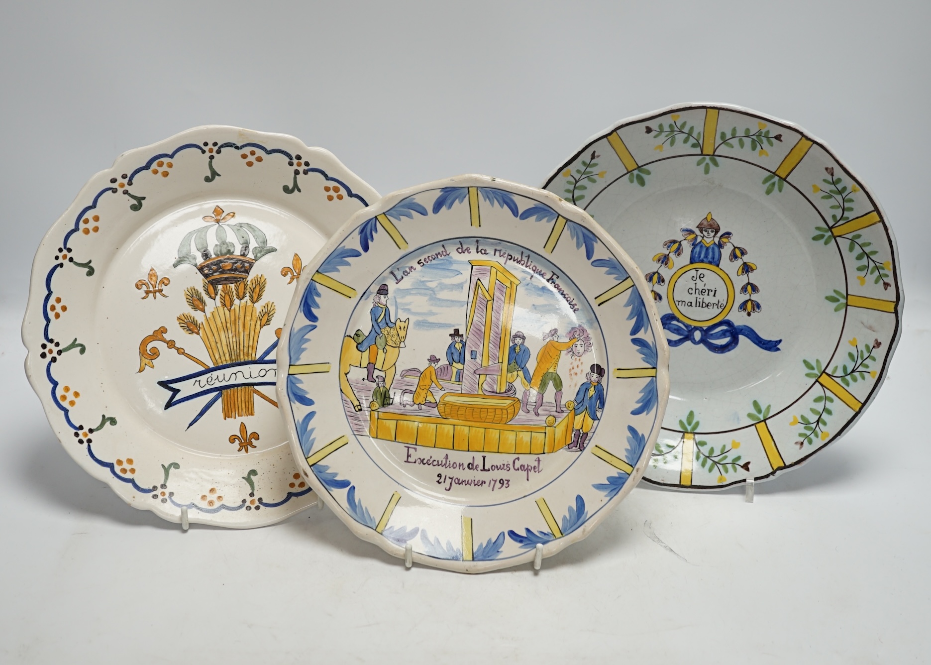 A collection of twenty 18th/19th century French faience polychrome and blue and white Revolution commemorative plates and three others, largest 27cm diameter (23)